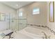 Luxurious bathroom showcasing a separate soaking tub and glass-enclosed shower at 15209 Montello Way, Bradenton, FL 34211