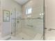 Beautiful bathroom with a glass-enclosed shower featuring stylish tile and a built-in bench at 15209 Montello Way, Bradenton, FL 34211