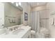 Bright bathroom with white cabinets, shower, and decorative accents at 15209 Montello Way, Bradenton, FL 34211