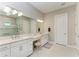 Elegant bathroom featuring dual vanities, a makeup area, and a walk-in shower at 15209 Montello Way, Bradenton, FL 34211