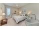 Comfortable bedroom with soft colors, a cozy chair, and plenty of natural light at 15209 Montello Way, Bradenton, FL 34211