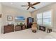 Cozy bedroom with neutral walls, dark wood furniture, plantation shutters, and a ceiling fan at 15209 Montello Way, Bradenton, FL 34211