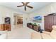 Bright bedroom featuring neutral paint, a ceiling fan, and a view to the formal dining room at 15209 Montello Way, Bradenton, FL 34211