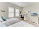 Comfortable bedroom with twin beds, neutral colors and a functional workspace at 15209 Montello Way, Bradenton, FL 34211