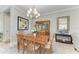 Well-lit dining room features a wooden table, china cabinet, and mirror, creating an inviting space at 15209 Montello Way, Bradenton, FL 34211