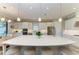 Bright, modern kitchen with a large island, white cabinetry, stainless steel appliances, and pendant lighting at 15209 Montello Way, Bradenton, FL 34211