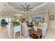 Cozy living room with ample seating, a ceiling fan, and views into the dining room at 15209 Montello Way, Bradenton, FL 34211