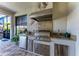 Outdoor kitchen featuring a stainless steel grill and granite countertops at 15209 Montello Way, Bradenton, FL 34211