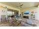 Relaxing covered patio with comfortable wicker furniture, ceiling fan, and outdoor television at 15209 Montello Way, Bradenton, FL 34211