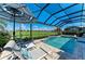 Screened-in pool and spa area with golf course views and lounge chairs at 15209 Montello Way, Bradenton, FL 34211