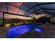 Beautiful pool and spa at dusk, featuring a screened-in enclosure and golf course views at 15209 Montello Way, Bradenton, FL 34211