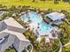 Aerial view of pool area surrounded by tropical landscaping, and lounge chairs at 16435 Umbria Pl, Bradenton, FL 34211