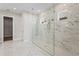 Bathroom featuring an oversized glass enclosed shower with marble tile at 16435 Umbria Pl, Bradenton, FL 34211