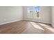 Bright bedroom featuring neutral paint, trim, tile floors, and two large windows at 16435 Umbria Pl, Bradenton, FL 34211