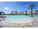 Beautiful zero entry pool and deck area with palm trees and Bahama Bar in the background at 16435 Umbria Pl, Bradenton, FL 34211