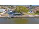 Aerial view of a single-Gathering home's waterfront location, dock, and screened-in pool at 1950 Fairview Dr, Englewood, FL 34223
