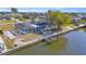 Aerial view of the property's canal front location, boat lift, and screened-in pool at 1950 Fairview Dr, Englewood, FL 34223