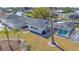 Aerial view of a waterfront home with screened-in pool, lush landscaping, and canal access at 1950 Fairview Dr, Englewood, FL 34223
