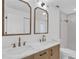 Modern bathroom with double vanity, marble countertops, gold fixtures, and tiled walk-in shower at 1950 Fairview Dr, Englewood, FL 34223