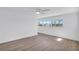 Empty bedroom with ample natural light, neutral décor, ceiling fan, and hardwood flooring at 1950 Fairview Dr, Englewood, FL 34223