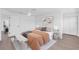 Well-lit bedroom with modern furnishings, neutral décor, ceiling fan, and hardwood flooring at 1950 Fairview Dr, Englewood, FL 34223