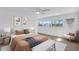Bright bedroom with ample natural light, neutral décor, ceiling fan, and hardwood flooring at 1950 Fairview Dr, Englewood, FL 34223