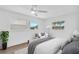 Bright bedroom boasts ample natural light, a ceiling fan, and neutral decor for a tranquil retreat at 1950 Fairview Dr, Englewood, FL 34223