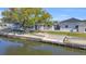 Waterfront home featuring a large tree, canal access, and a new dock at 1950 Fairview Dr, Englewood, FL 34223