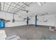 This spacious garage has high ceilings, car lifts, and plenty of room for storage or a workshop at 1950 Fairview Dr, Englewood, FL 34223