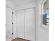 Hallway with white double closet doors, white walls, and tile flooring at 1950 Fairview Dr, Englewood, FL 34223