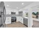 Bright kitchen features stainless appliances, white cabinets and tile backsplash at 1950 Fairview Dr, Englewood, FL 34223