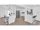 Open kitchen featuring bar seating, stainless steel appliances, white cabinetry, and modern backsplash at 1950 Fairview Dr, Englewood, FL 34223