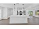 Modern kitchen featuring white cabinets, quartz countertops, and stylish pendant lighting at 1950 Fairview Dr, Englewood, FL 34223