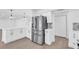 Kitchen with stainless refrigerator and white cabinets at 1950 Fairview Dr, Englewood, FL 34223
