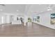 Bright, open-concept living space with wood floors and views of the waterfront at 1950 Fairview Dr, Englewood, FL 34223