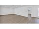 Bright and open living room with wood floors and access to the front entryway at 1950 Fairview Dr, Englewood, FL 34223