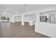 Open-concept living area with pool view, stylish island and stainless steel appliances at 1950 Fairview Dr, Englewood, FL 34223