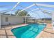 Inviting screened-in pool features a brick pool deck and view of the canal at 1950 Fairview Dr, Englewood, FL 34223