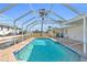 Inviting pool with cool blue water, brick trim and a screened enclosure to maximize enjoyment at 1950 Fairview Dr, Englewood, FL 34223