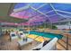 Cozy outdoor living space with a stunning pool and stylish seating, ideal for relaxation and entertaining at 1950 Fairview Dr, Englewood, FL 34223
