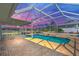 Screened-in pool with brick pool deck overlooks a canal during a gorgeous sunset at 1950 Fairview Dr, Englewood, FL 34223