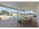 Stunning screened pool area with an outdoor dining setup, creating a perfect setting for relaxation at 1950 Fairview Dr, Englewood, FL 34223