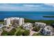 Stunning aerial view of waterfront condos with lush landscaping and tranquil bay views at 2012 Harbourside Dr # 2104, Longboat Key, FL 34228