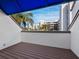 Balcony with blue canopy and a beautiful view of the condos and palm trees at 2012 Harbourside Dr # 2104, Longboat Key, FL 34228