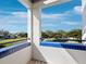 Balcony with blue tiles and views of the lawn, palm trees, and blue sky at 2012 Harbourside Dr # 2104, Longboat Key, FL 34228