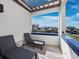 Relaxing balcony with lounge chairs and a pergola offers a serene view of the community and bright blue skies at 2012 Harbourside Dr # 2104, Longboat Key, FL 34228