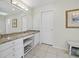 Bright bathroom with a granite countertop, built-in vanity, and tiled floors at 2012 Harbourside Dr # 2104, Longboat Key, FL 34228