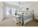 Well-lit main bedroom boasts large windows, neutral carpeting, and a comfortable iron-frame bed with plush linens at 2012 Harbourside Dr # 2104, Longboat Key, FL 34228