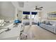 Bedroom/Office featuring a ceiling fan, a balcony, and a comfortable sitting area at 2012 Harbourside Dr # 2104, Longboat Key, FL 34228