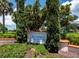 Community sign featuring Longboat Key Club, with green bushes and lovely landscaping at 2012 Harbourside Dr # 2104, Longboat Key, FL 34228